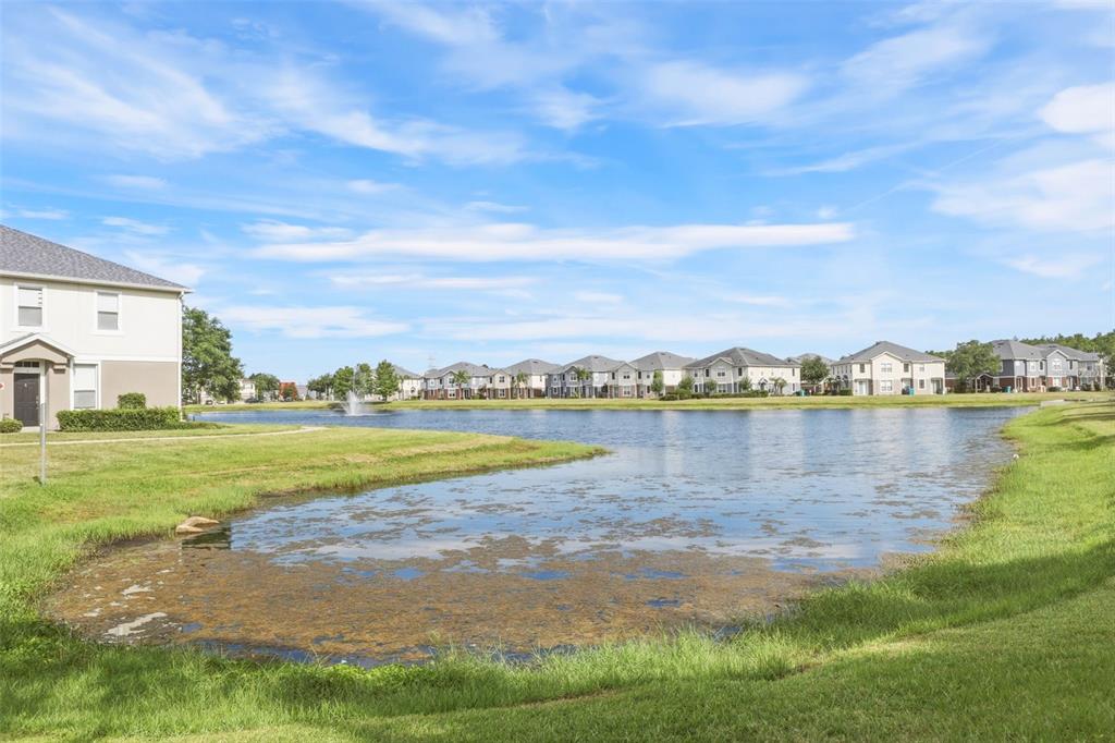 6458 South Goldenrod Road, Unit 29B Orlando, FL 32822 - Photo 29 of 40 a view of a lake with houses in the back