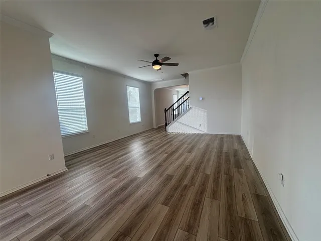 wooden floor in an empty room with a window