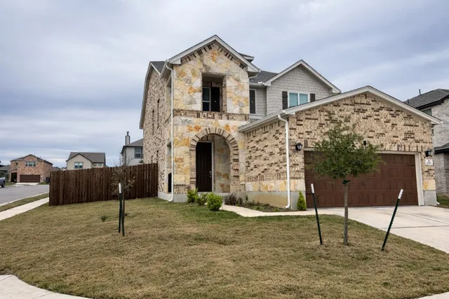 a front view of a house with a yard