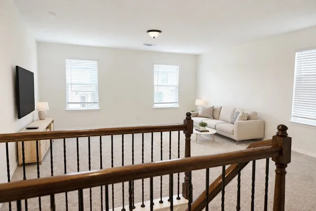 a view of a room with furniture and windows