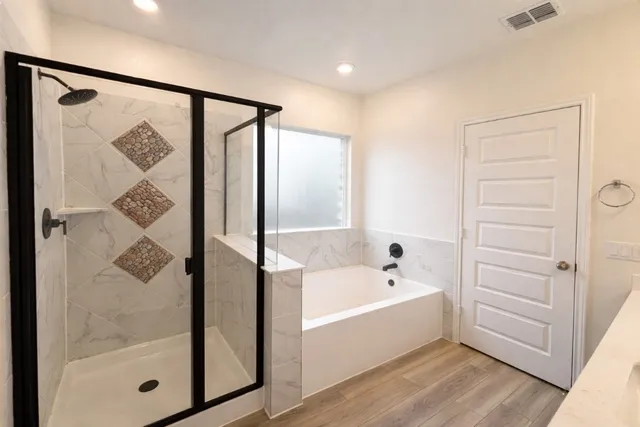 a bathroom with a bathtub and a shower