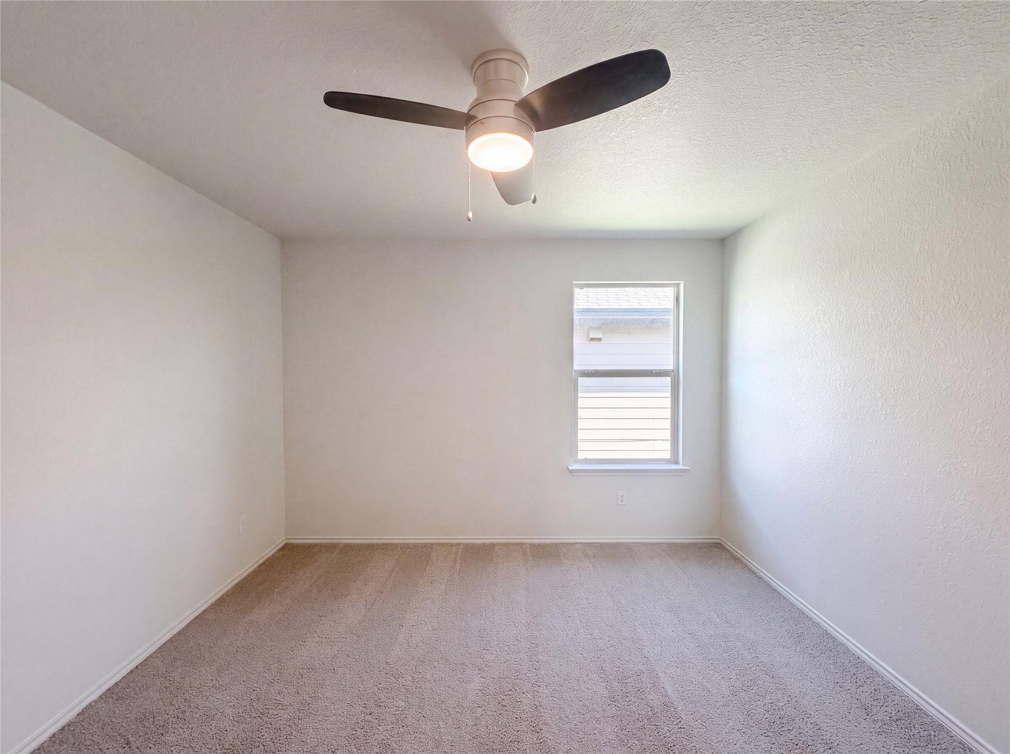 233 Atwood Loop Jarrell, TX 76537 - Photo 10 of 15 Soft carpeting pairs with neutral walls and a single window to create a serene space.