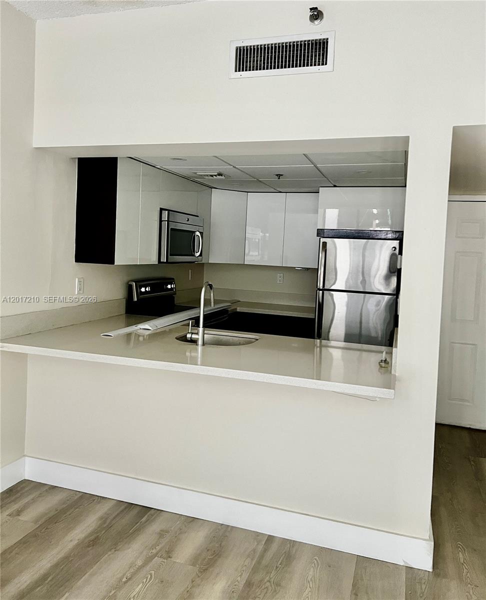 540 Brickell Key Drive, Unit 218 Miami, FL 33131 - Photo 4 of 12 a view of a kitchen with a sink and an oven