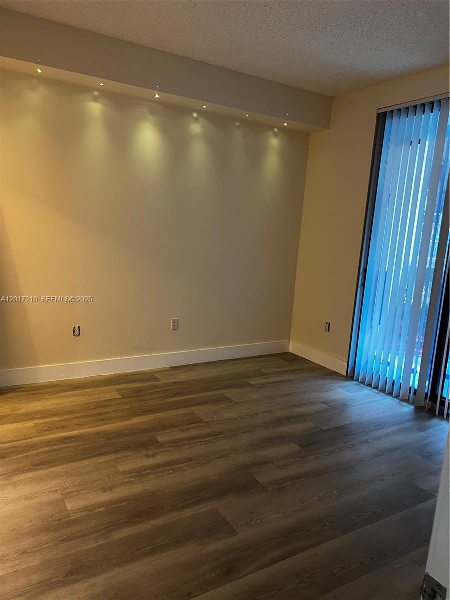 540 Brickell Key Drive, Unit 218 Miami, FL 33131 - Photo 6 of 12 a view of a room with wooden floor