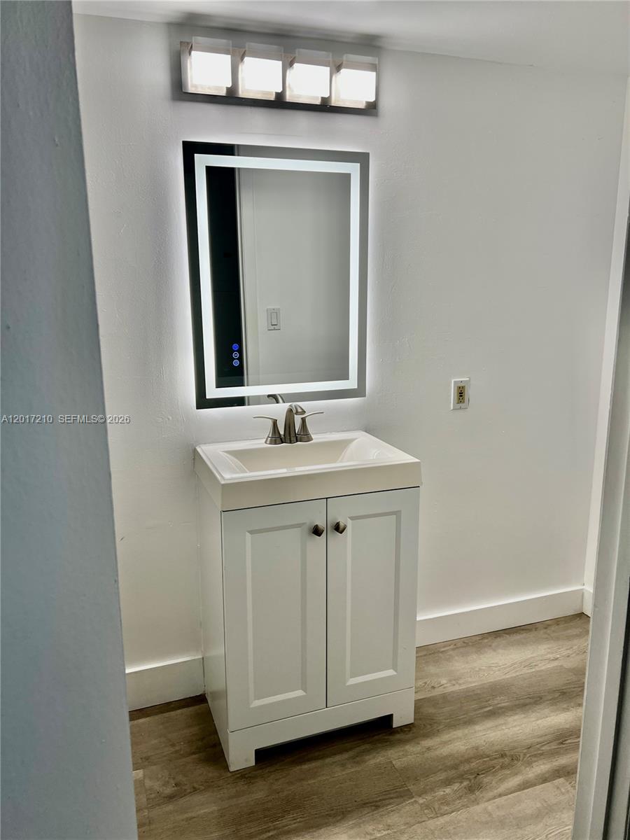540 Brickell Key Drive, Unit 218 Miami, FL 33131 - Photo 8 of 12 a bathroom with a sink vanity and mirror