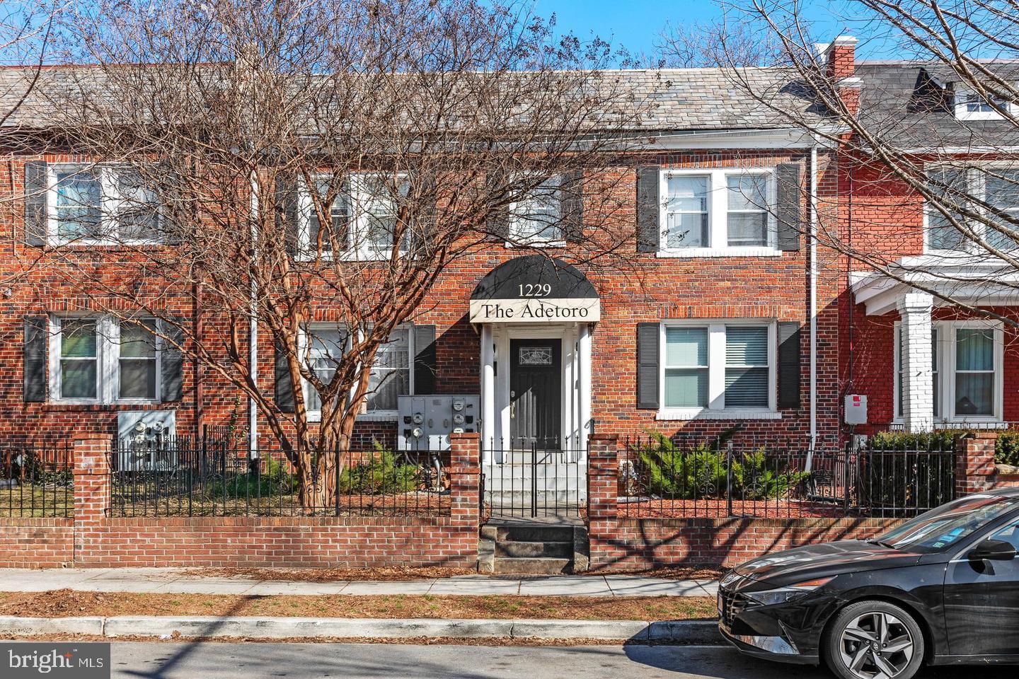 1229 18th Street Northeast, Unit 201 Washington, DC 20002 - Photo 1 of 14 a front view of a house with parking area
