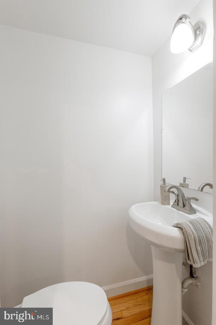 1229 18th Street Northeast, Unit 201 Washington, DC 20002 - Photo 11 of 14 a bathroom with a sink a toilet and a mirror