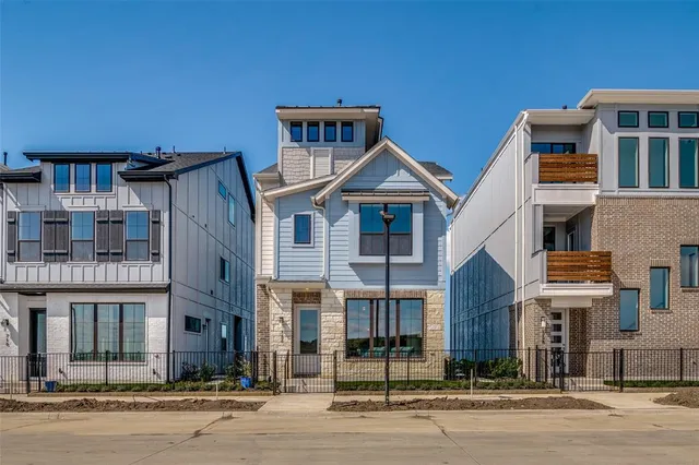 a front view of a residential apartment building with a street