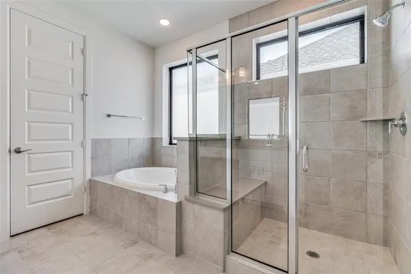 a bathroom with a tub and shower