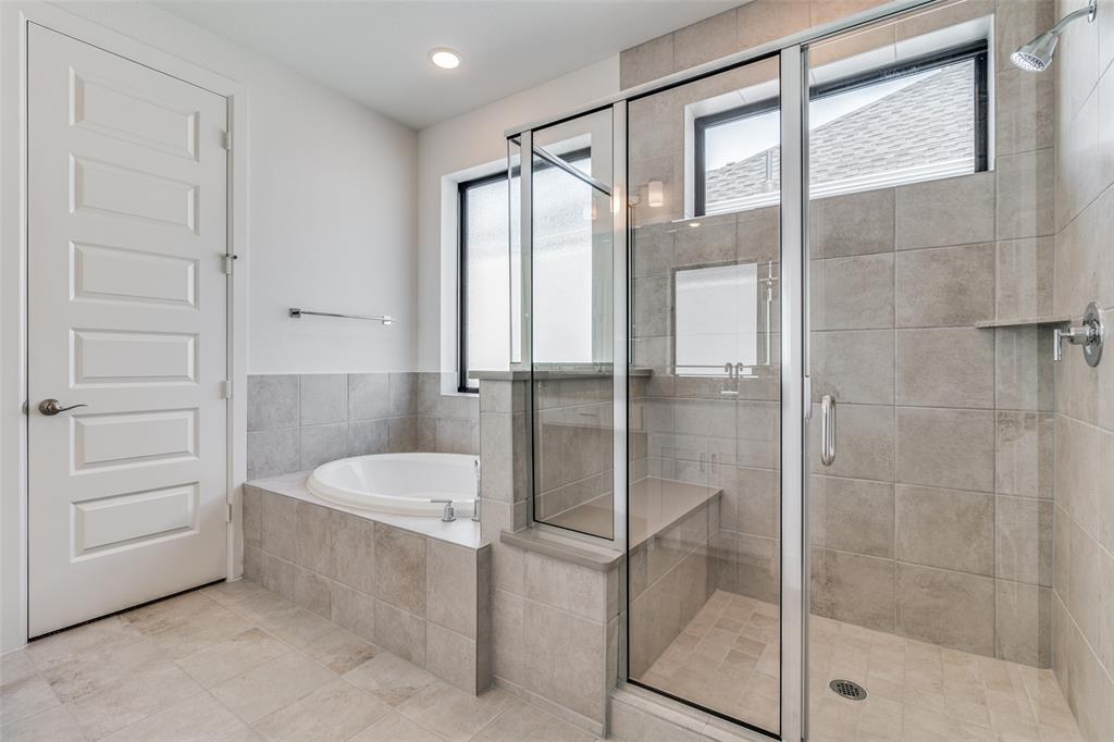 722 Resort Drive Rowlett, TX 75088 - Photo 13 of 24 a bathroom with a tub and shower