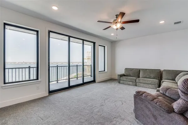 a living room with furniture and a ceiling fan
