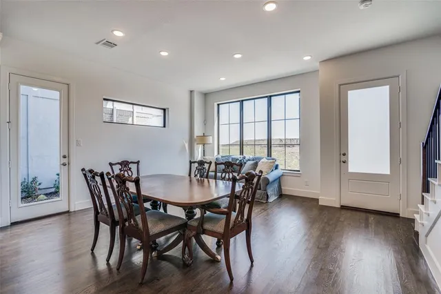 a view of a a dining room with furniture window and wooden floor