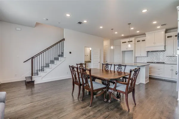 a dining room with furniture and wooden floor