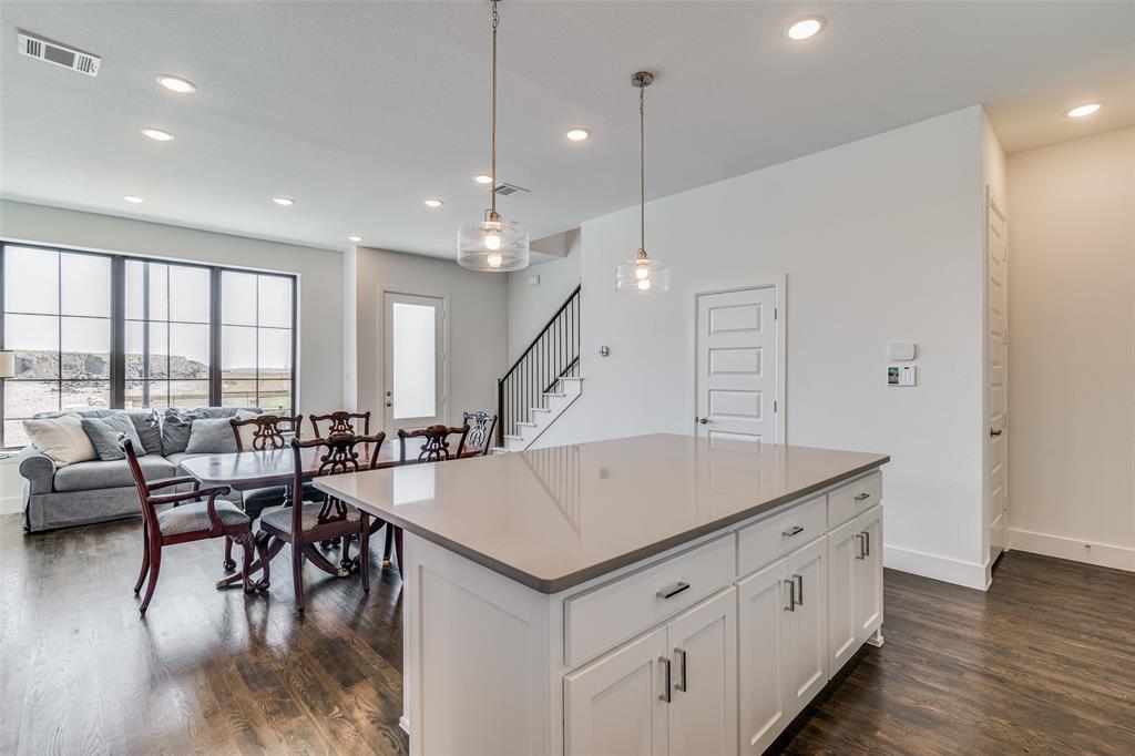 722 Resort Drive Rowlett, TX 75088 - Photo 7 of 24 a room with lots of wooden furniture and a chandelier