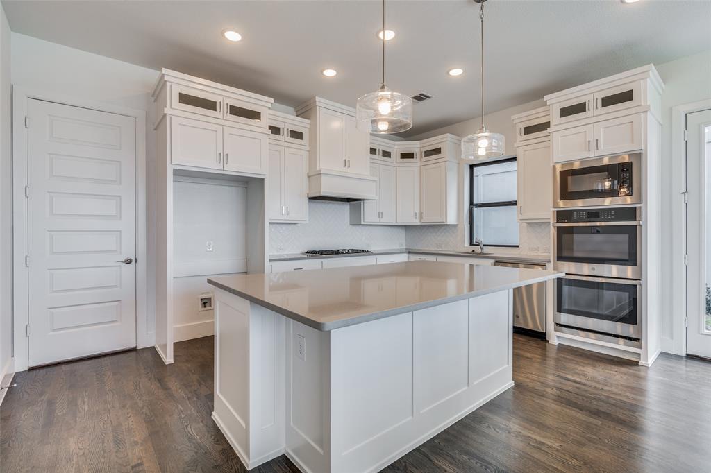 722 Resort Drive Rowlett, TX 75088 - Photo 9 of 24 a large kitchen with stainless steel appliances kitchen island granite countertop a large stove a sink and a refrigerator