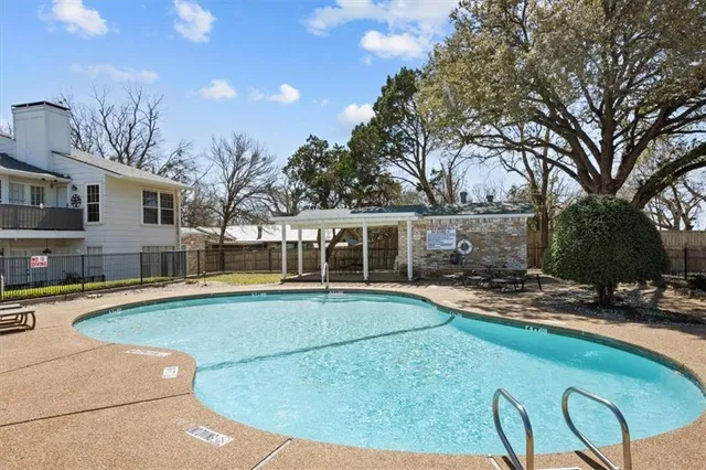 a view of a swimming pool with a table and chairs