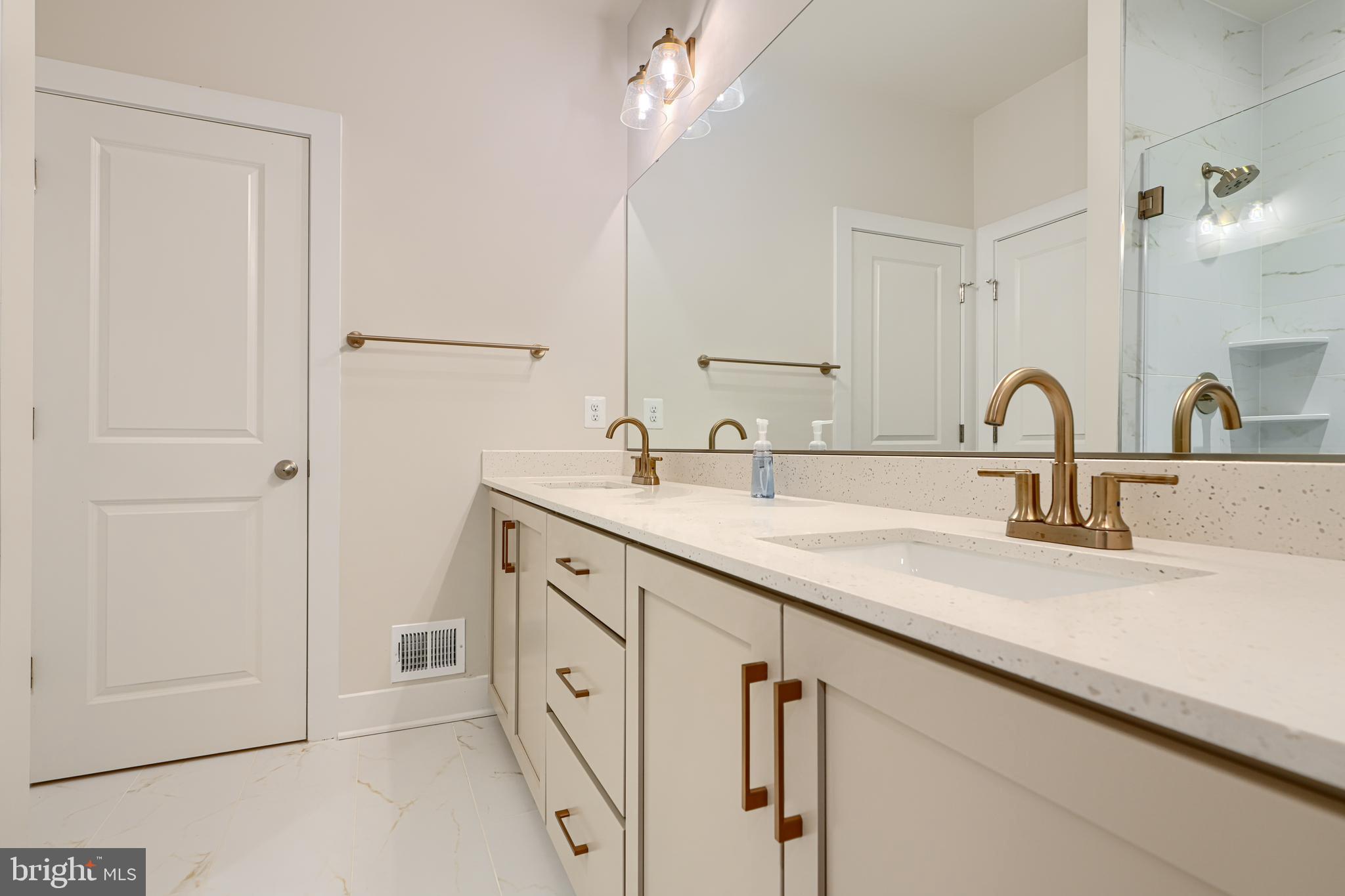2603 Light Street Baltimore, MD 21230 - Photo 17 of 29 a bathroom with double sink a mirror and shower
