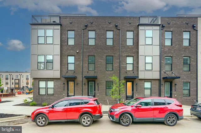 a car parked in front of a big house