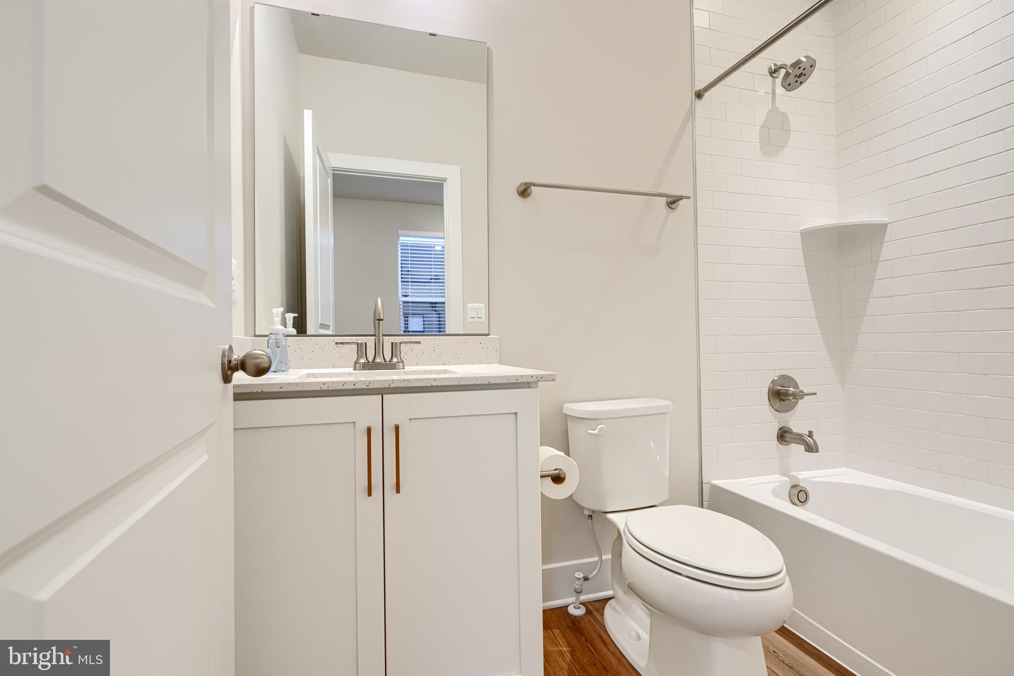 2603 Light Street Baltimore, MD 21230 - Photo 22 of 29 a bathroom with a sink a toilet and shower