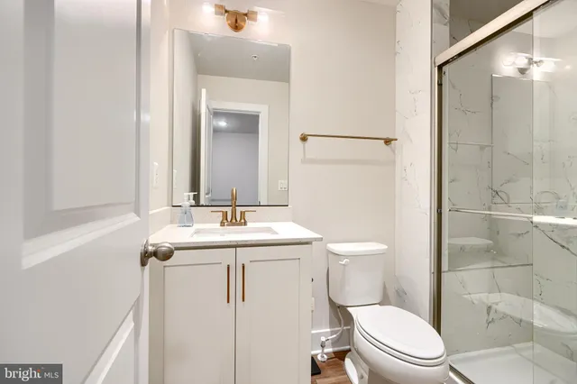 a bathroom with a glass shower door