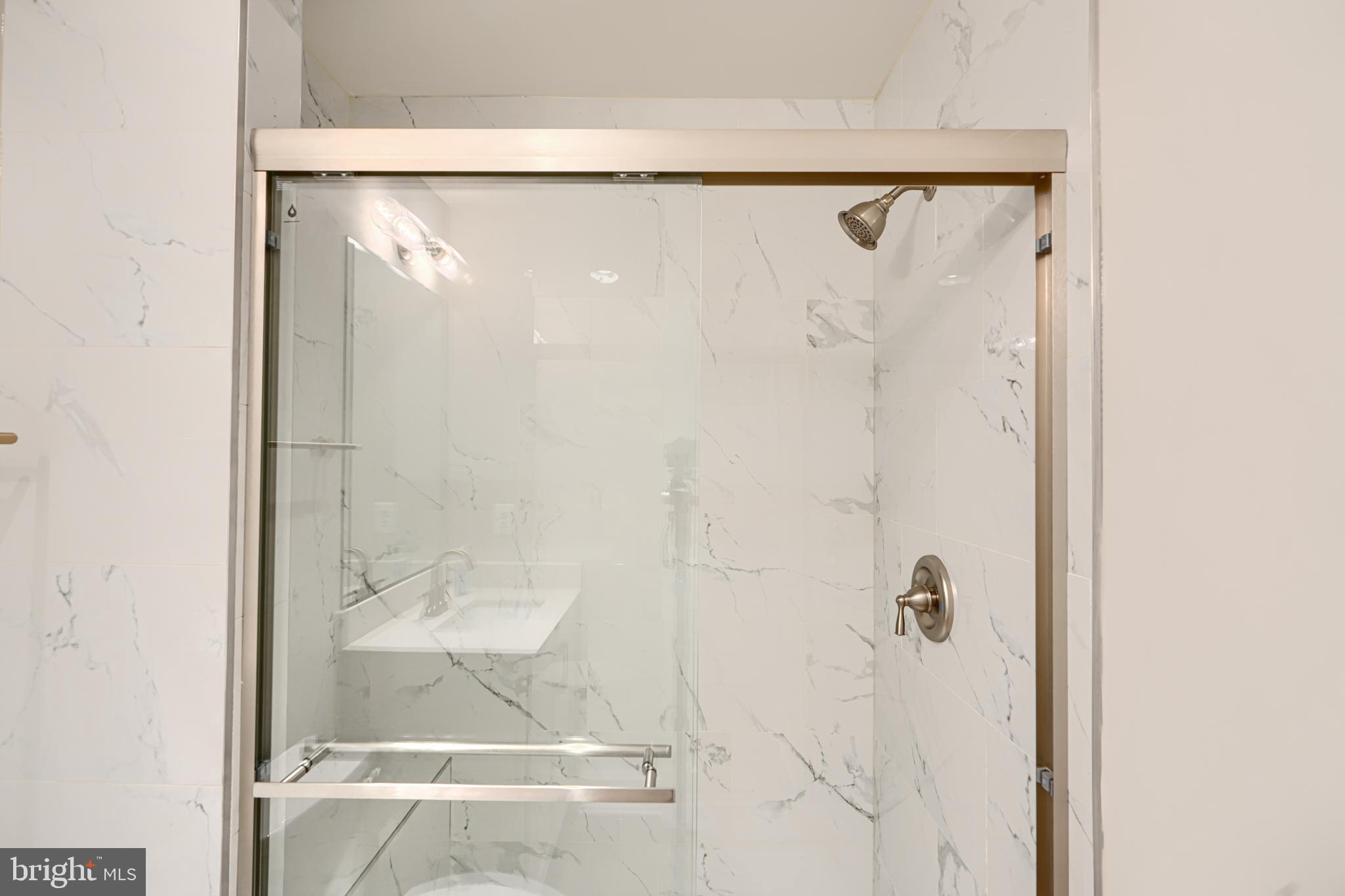 2603 Light Street Baltimore, MD 21230 - Photo 26 of 29 a bathroom with a glass shower door