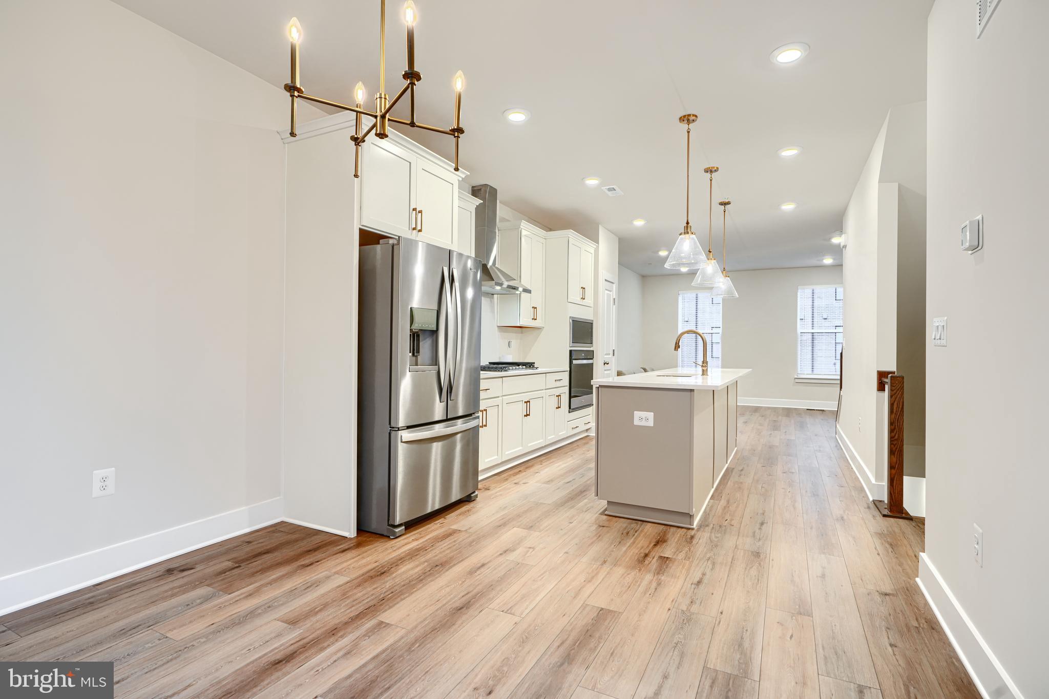 2603 Light Street Baltimore, MD 21230 - Photo 8 of 29 a kitchen with a refrigerator a sink and wooden floor