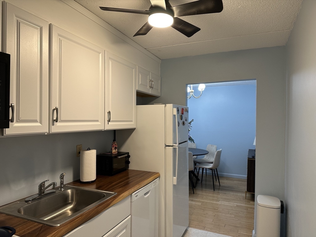 95 Nahant Street, Unit 12 Lynn, MA 01902 - Photo 15 of 28 a kitchen with a refrigerator a sink and cabinets