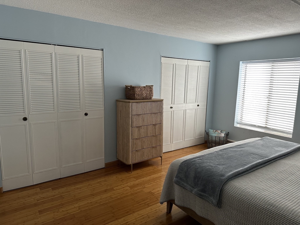 95 Nahant Street, Unit 12 Lynn, MA 01902 - Photo 17 of 28 a bedroom with a bed and wooden floor