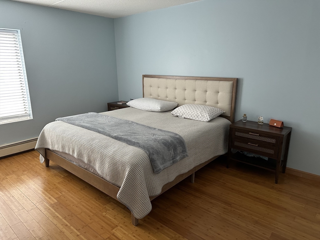 95 Nahant Street, Unit 12 Lynn, MA 01902 - Photo 18 of 28 a large bed sitting in a bedroom next to a window