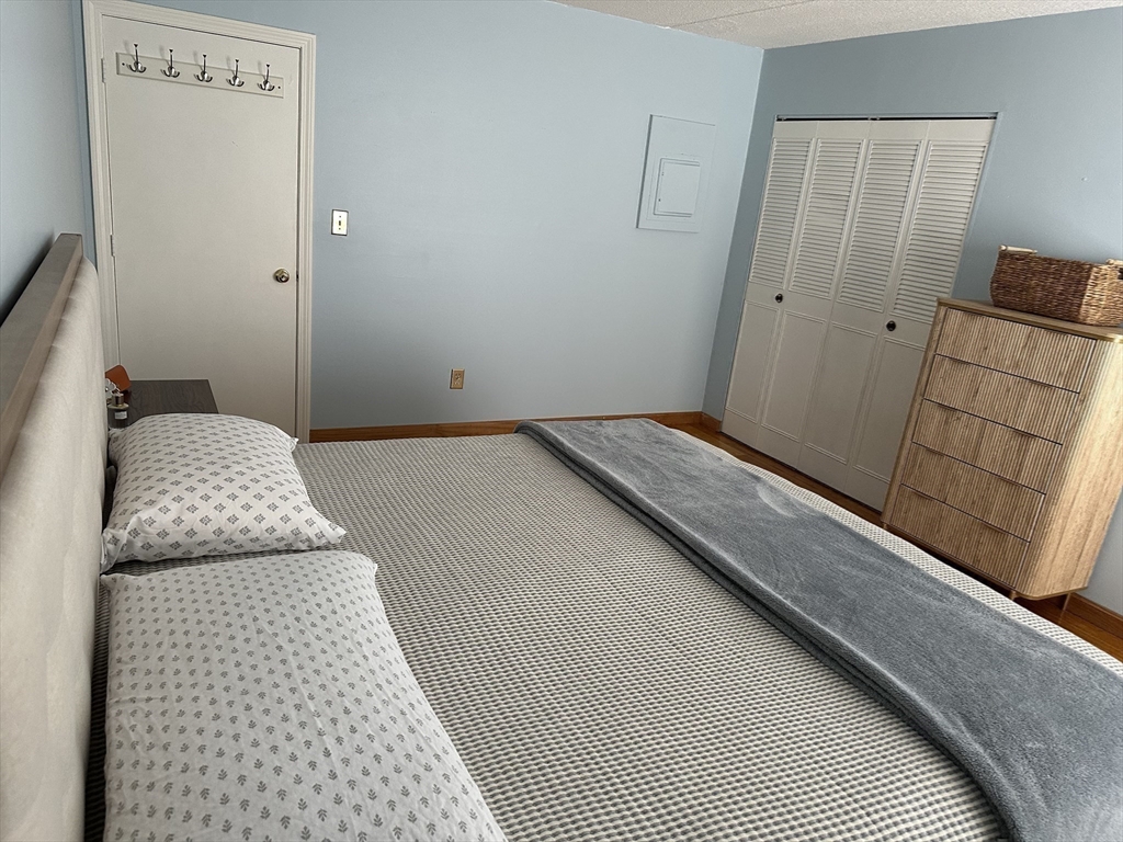 95 Nahant Street, Unit 12 Lynn, MA 01902 - Photo 20 of 28 a bedroom with a bed and wooden floor