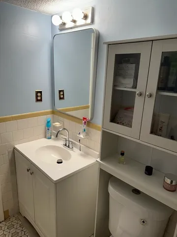 a bathroom with a sink vanity and mirror
