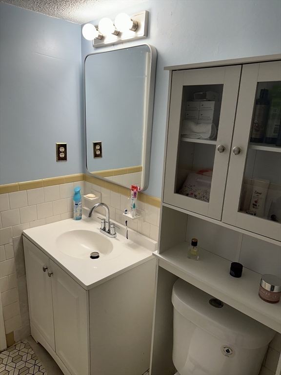 95 Nahant Street, Unit 12 Lynn, MA 01902 - Photo 22 of 28 a bathroom with a sink vanity and mirror