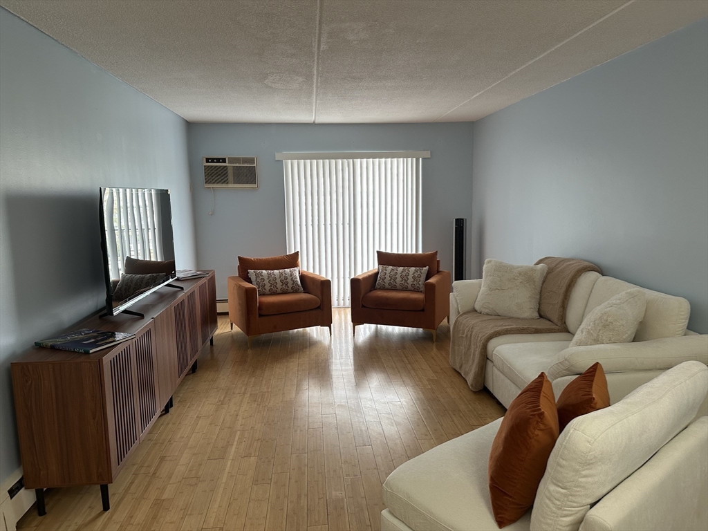 95 Nahant Street, Unit 12 Lynn, MA 01902 - Photo 6 of 28 a living room with furniture and a flat screen tv