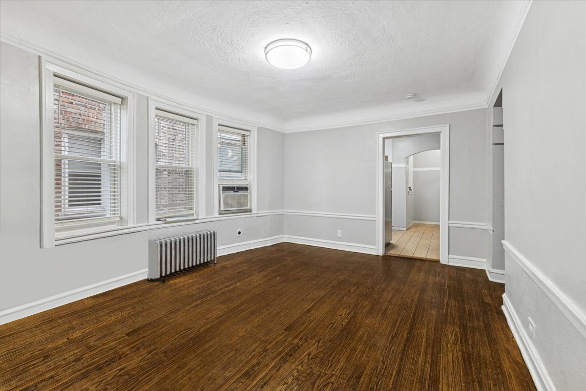 1311 West 91st Street Chicago, IL 60620 - Photo 11 of 19 a view of an empty room with wooden floor and a window
