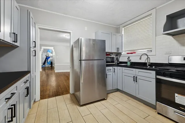 a kitchen with a refrigerator a sink and a stove