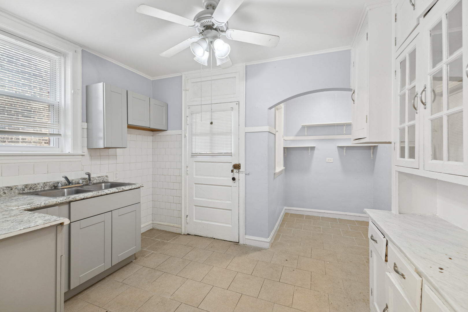 1311 West 91st Street Chicago, IL 60620 - Photo 7 of 19 a kitchen with white cabinets and appliances