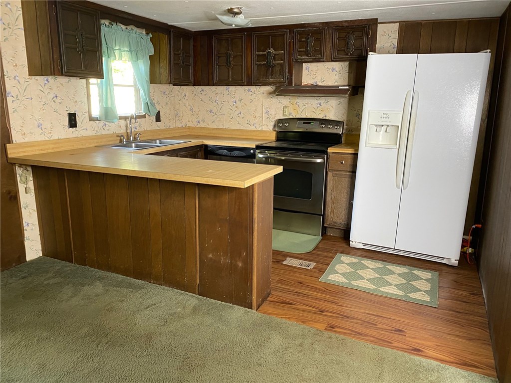 54899 Church Road Callahan, FL 32011 - Photo 14 of 35 a kitchen with a refrigerator stove and sink