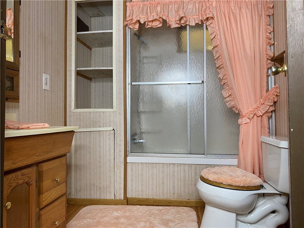 54899 Church Road Callahan, FL 32011 - Photo 17 of 35 a bathroom with a toilet and a shower