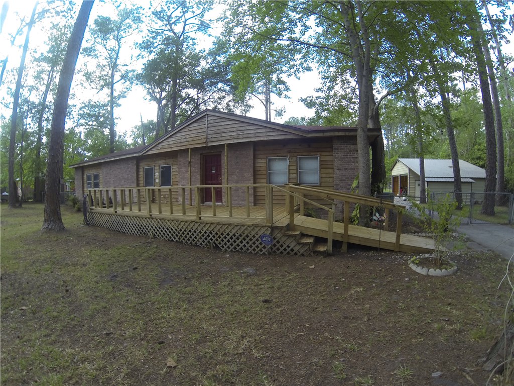54899 Church Road Callahan, FL 32011 - Photo 2 of 35 a view of a house with a yard and sitting area
