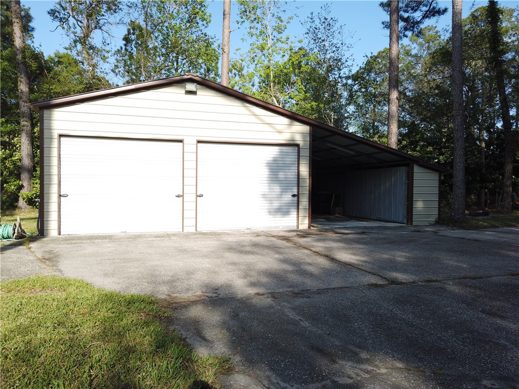 54899 Church Road Callahan, FL 32011 - Photo 22 of 35 a backyard of a house with large trees