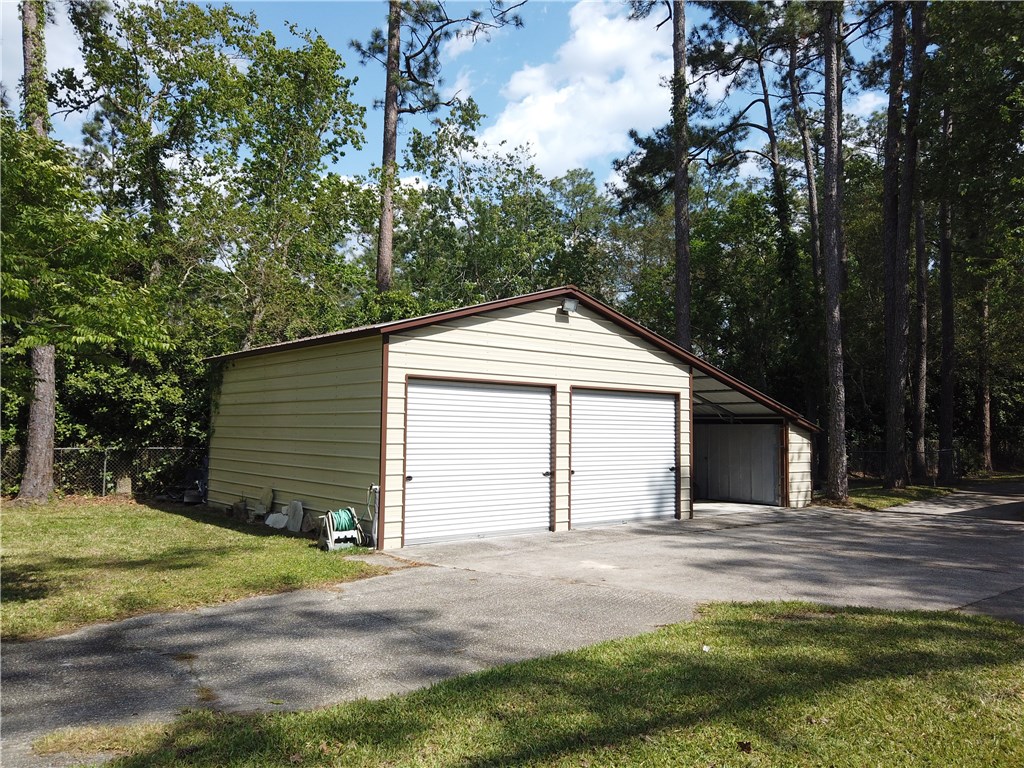 54899 Church Road Callahan, FL 32011 - Photo 24 of 35 a view of backyard of house with garage