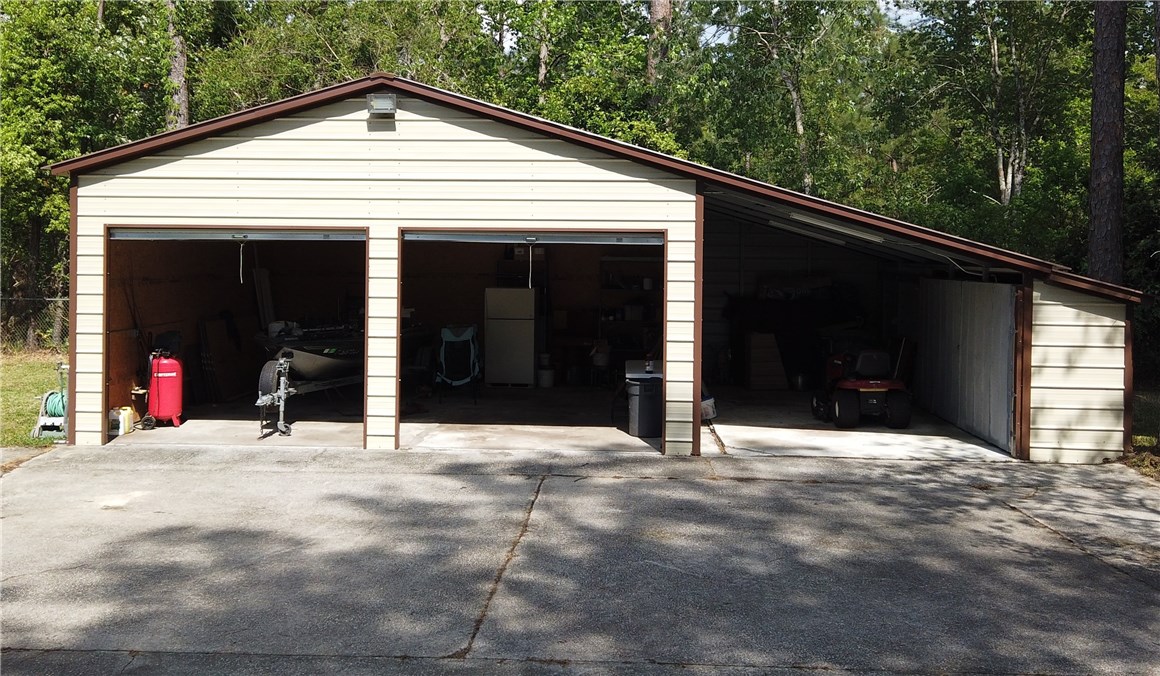 54899 Church Road Callahan, FL 32011 - Photo 25 of 35 a view of a house with a garage