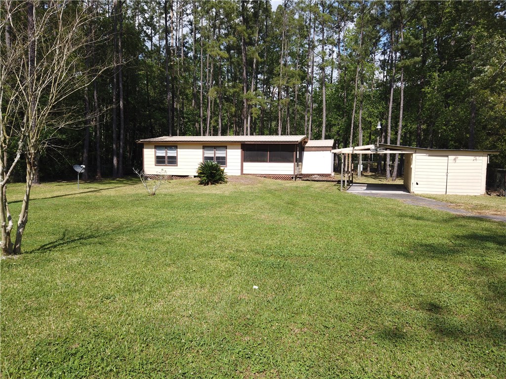 54899 Church Road Callahan, FL 32011 - Photo 29 of 35 a view of a house with backyard and sitting area