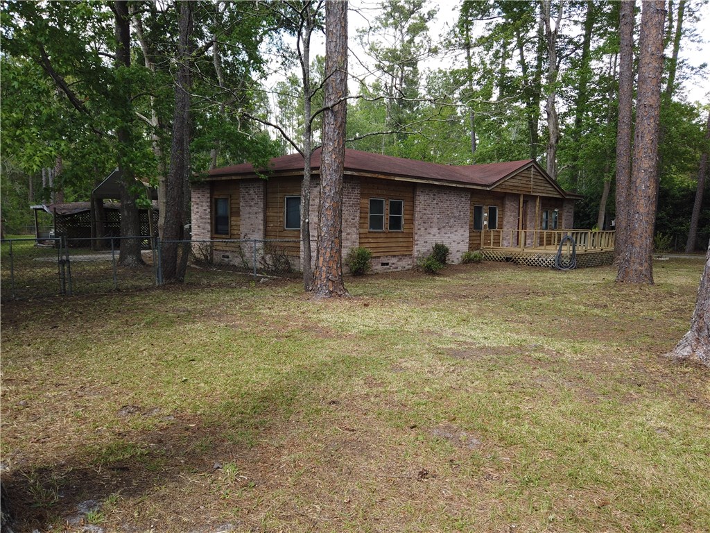 54899 Church Road Callahan, FL 32011 - Photo 3 of 35 a big house with large trees and wooden fence