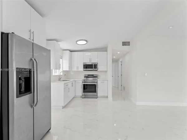 a kitchen with a refrigerator and a stove
