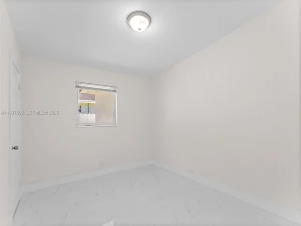 an empty room with a empty space and window