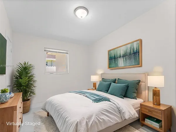 a bedroom with a bed and a potted plant