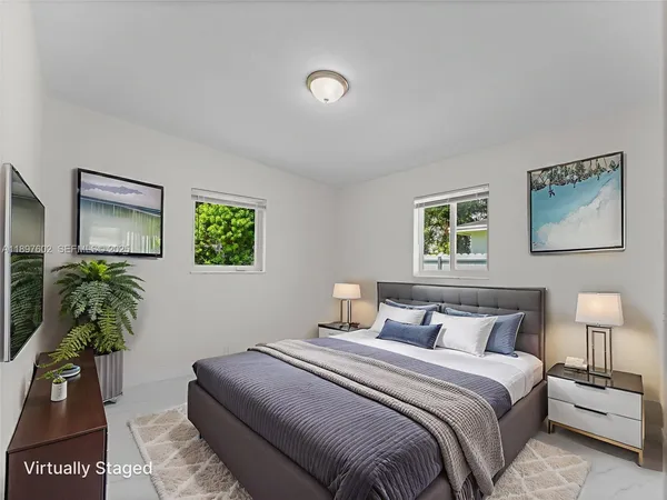 a bedroom with bed and a potted plant