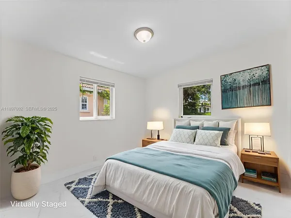 a bedroom with a bed and a painting on the wall