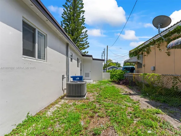 a view of backyard with plants and outdoor seating